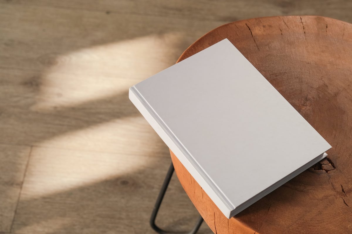 Book cover template on wooden table with elegant shadow